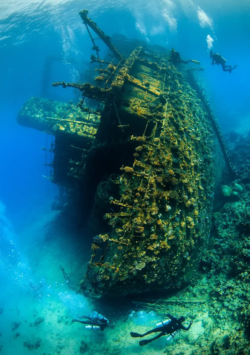 the wreck of giannis d underwater with scuba divers