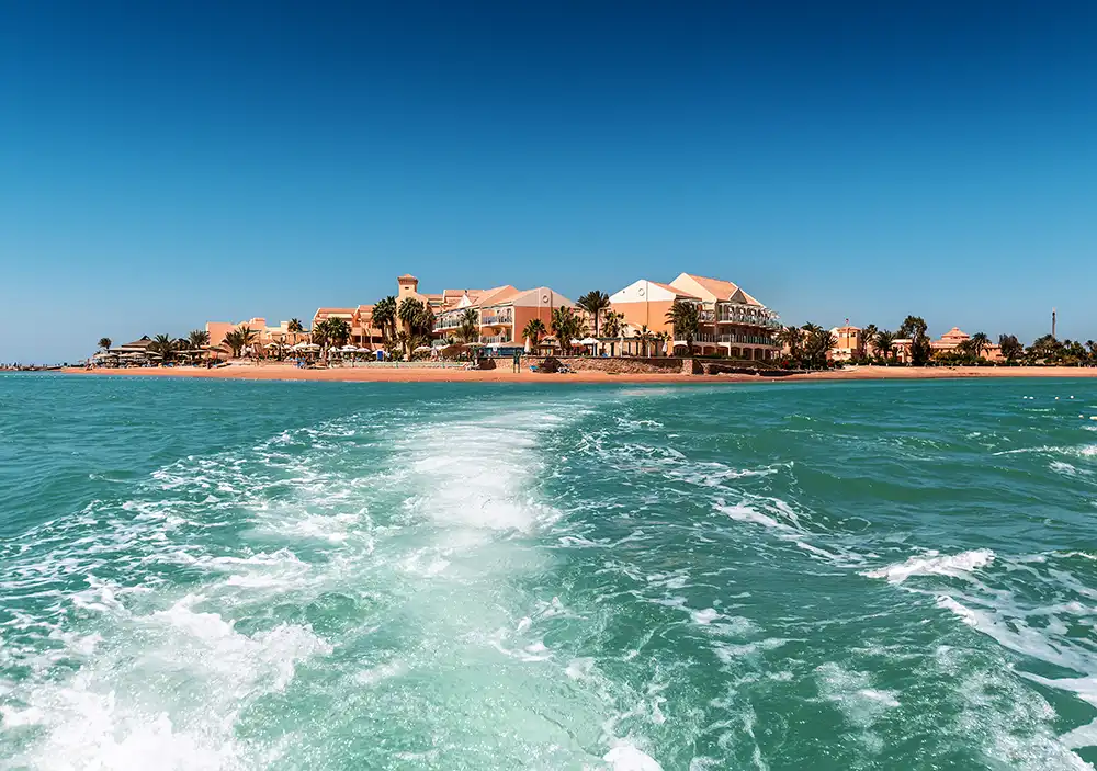 on a boat looking backwards at the wake sailing away from el gouna