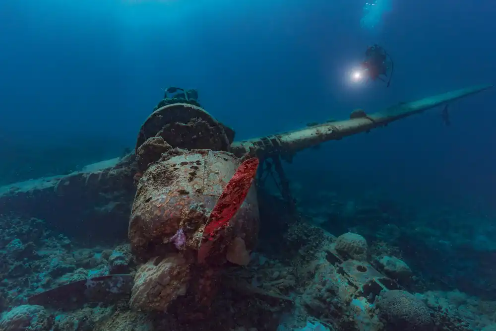 Diver above a Japanese Navy Jake seaplane wreck in Palau