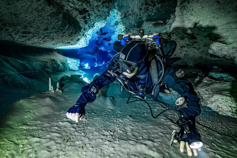 a scuba diver in a case system wearing the halcyon symbios handset and heads up display