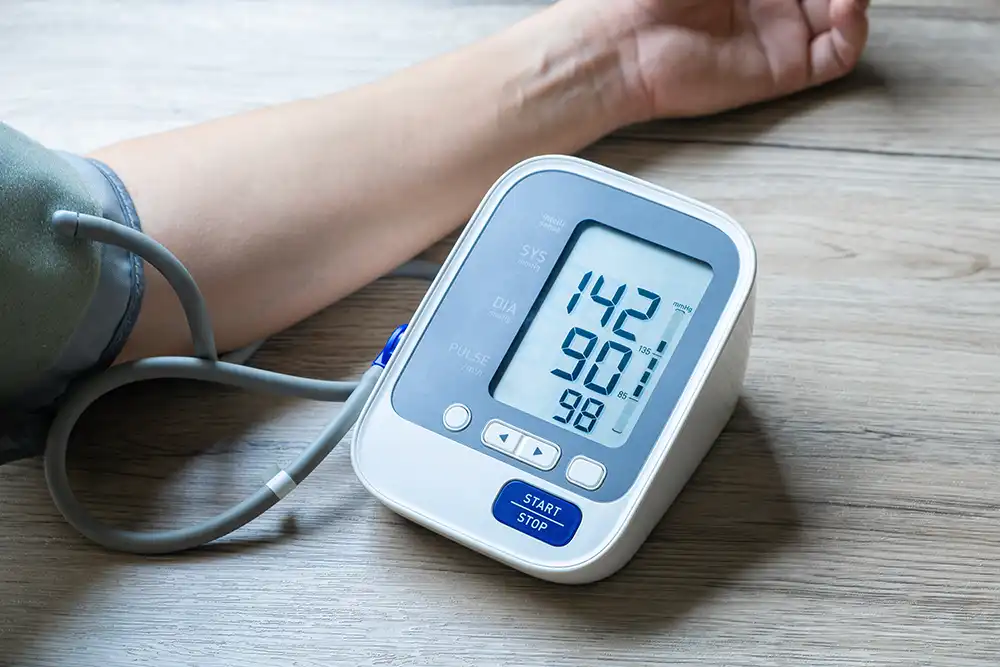 person taking a blood pressure reading with home monitor