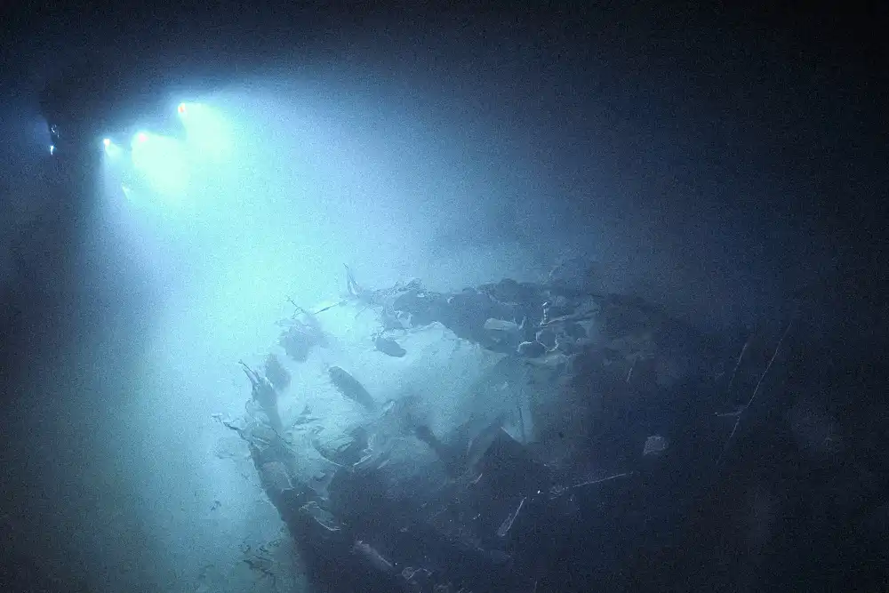A picture of a remote opertad vehicle submarine, the ROV Hercules inspecting the stern section of a sunken Japanese battleship