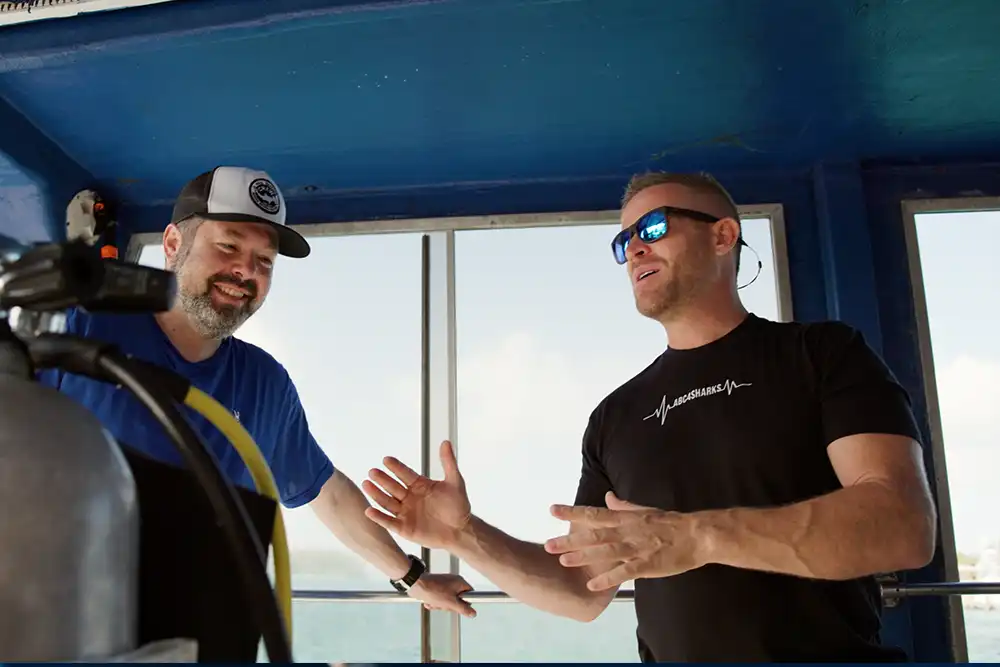 shark experts Ari Rabin-Havt and Andy Casagrande discussing sharks on a boat