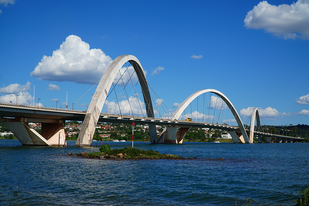 A photograph of the Juscelino Kubitschek Bridge (JK Bridge) crossing Lake Paranoa, Brazil