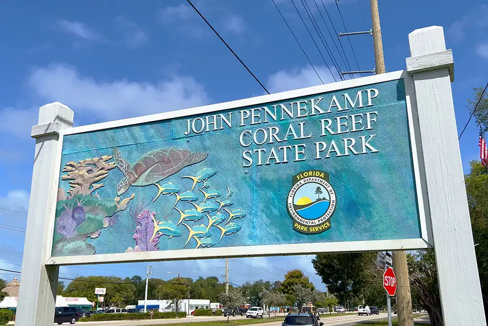 a large roadside sign welcoming visitors to the  John Pennekamp Coral Reef State Park