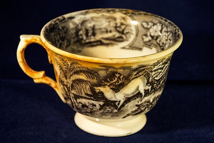 a ceramic teacup with a unique woodland design