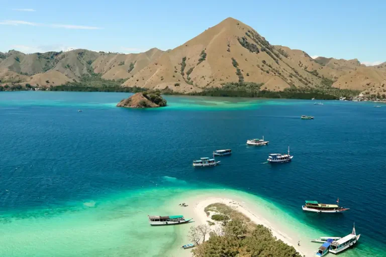 dive boats blue seas coral reefs and mountains in komodo national park