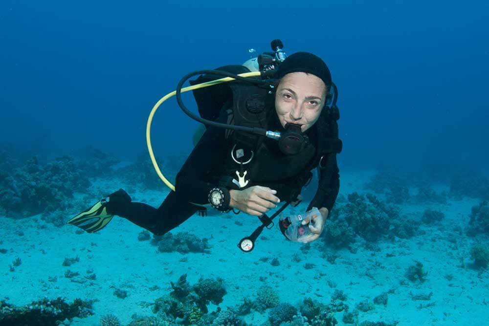 scuba diver with mask removed underwater