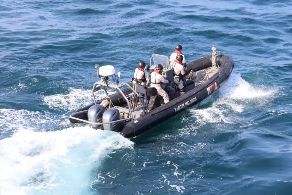 a malaysian maritime enforcement agency small boat at sea with four crew