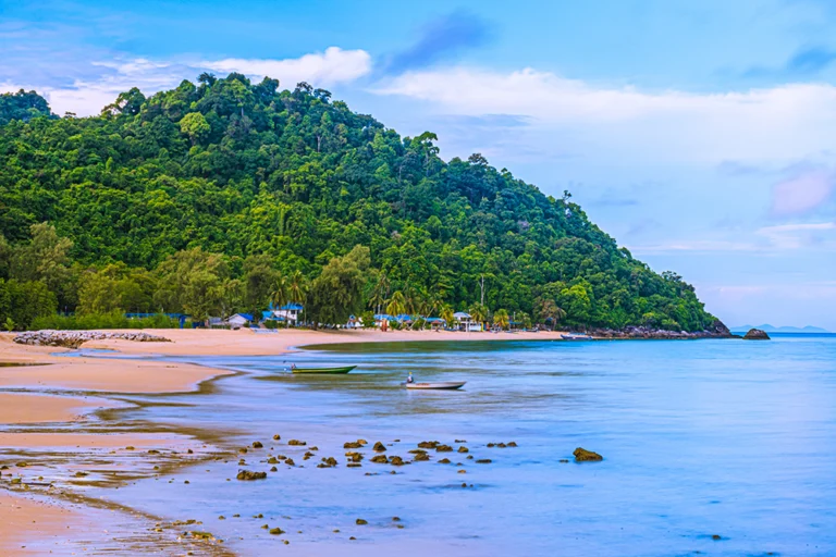 a beach and boat at pulau tioman island