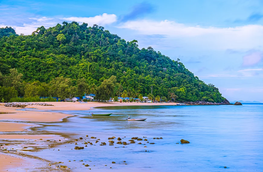 a beach and boat at pulau tioman island