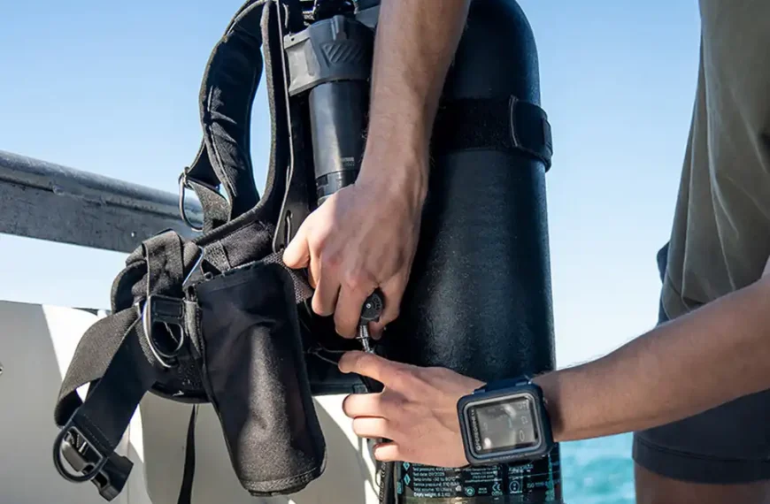 A diver adjusts the Shearwater Jetpack attached to an Avelo Hydrotank on a boat