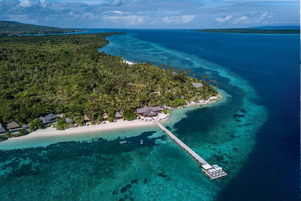 Aerial view of Wakatobi Dive Resort, its jetty and the shallow House Reef